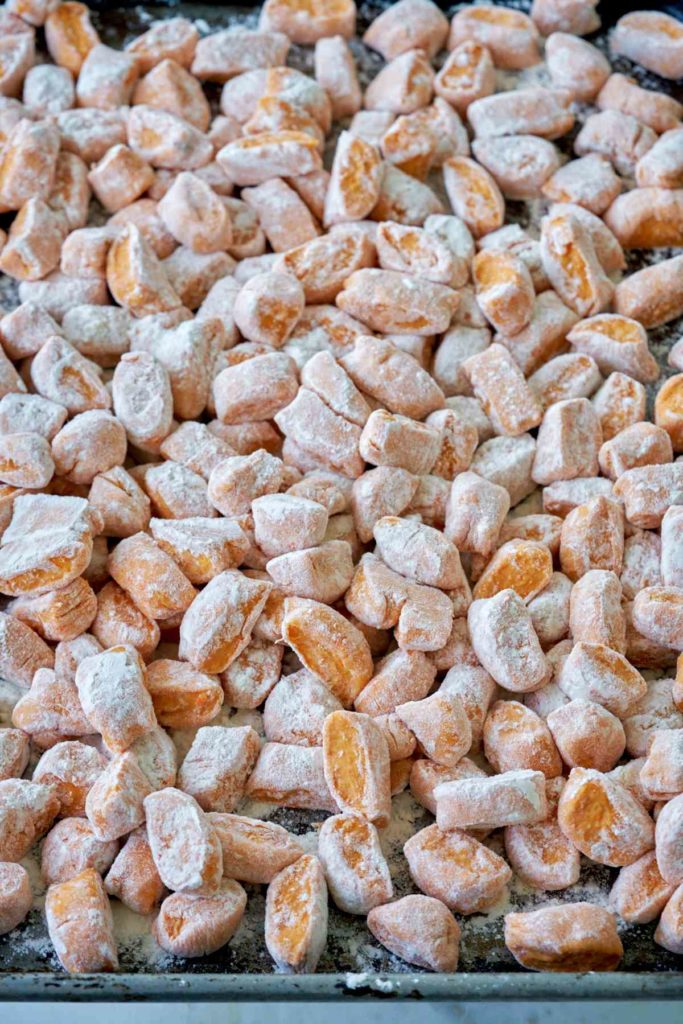 Sweet potato gnocchi on a baking sheet.