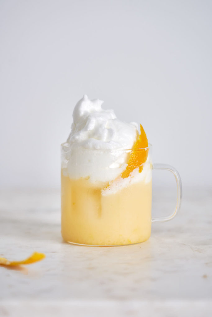 Whipped orange creamsicle in a clear glass.
