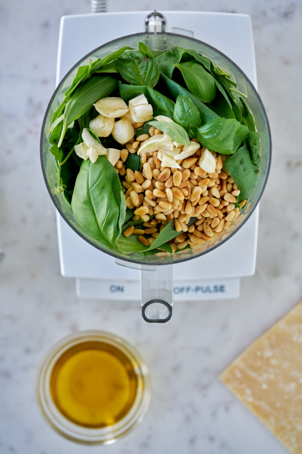 Pesto ingredients in a food processor.