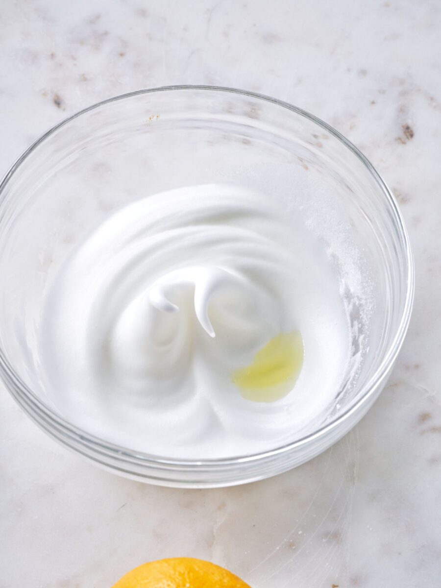 Whipped egg bites in a glass bowl with a small amount of yellow oil.