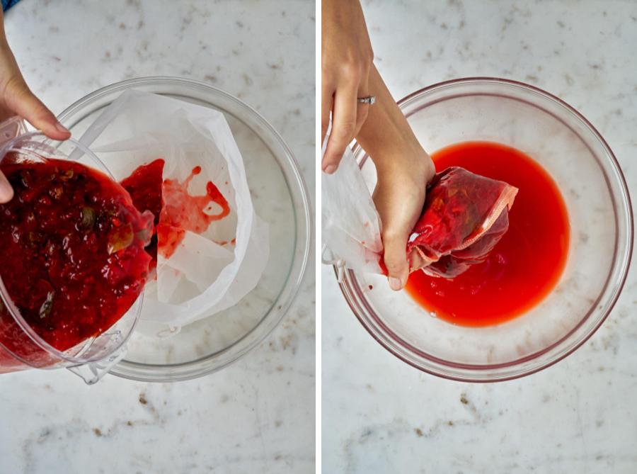 Straining strawberry shrub through a nut milk bag into a clear bowl.