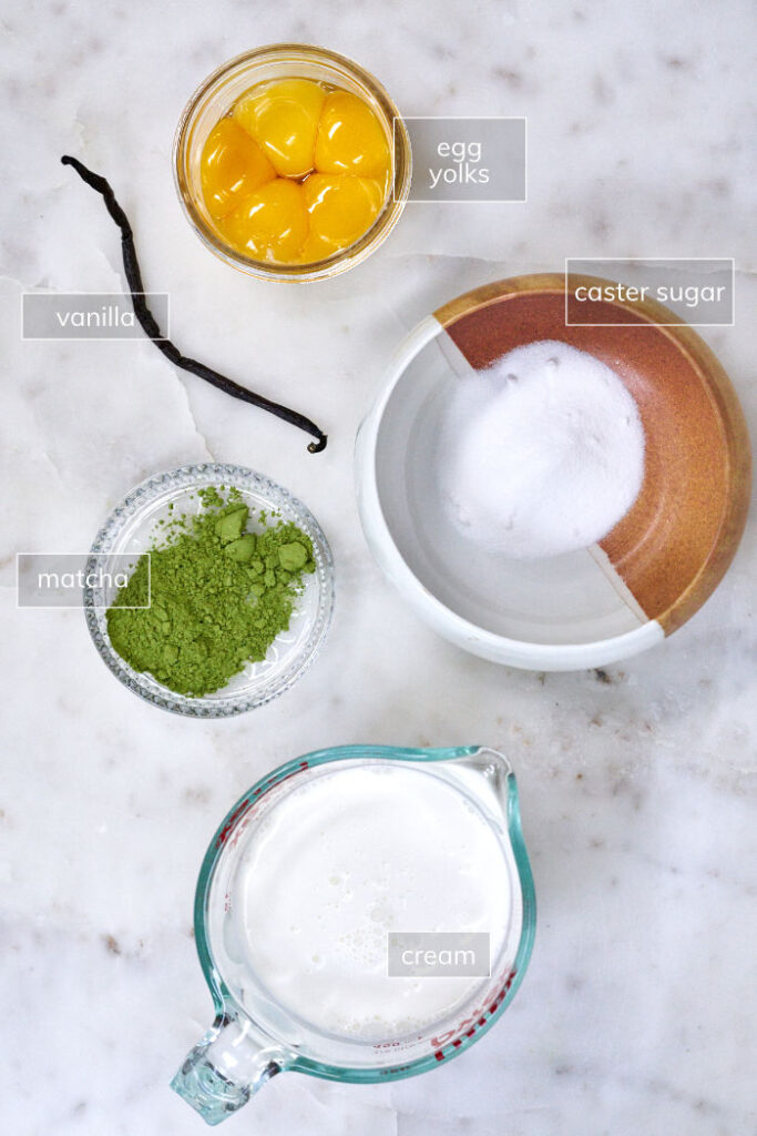 Ingredients for matcha creme brulee including vanilla, matcha, cream, yolks, and sugar.