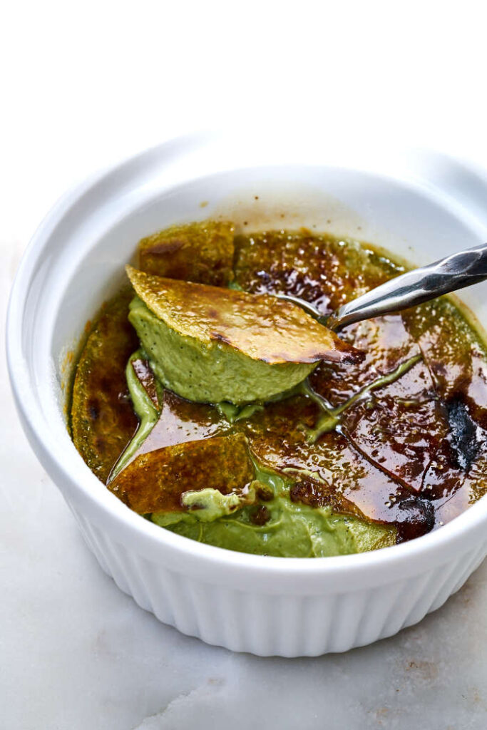 A spoon scooping out a bite of green tea creme brulee.