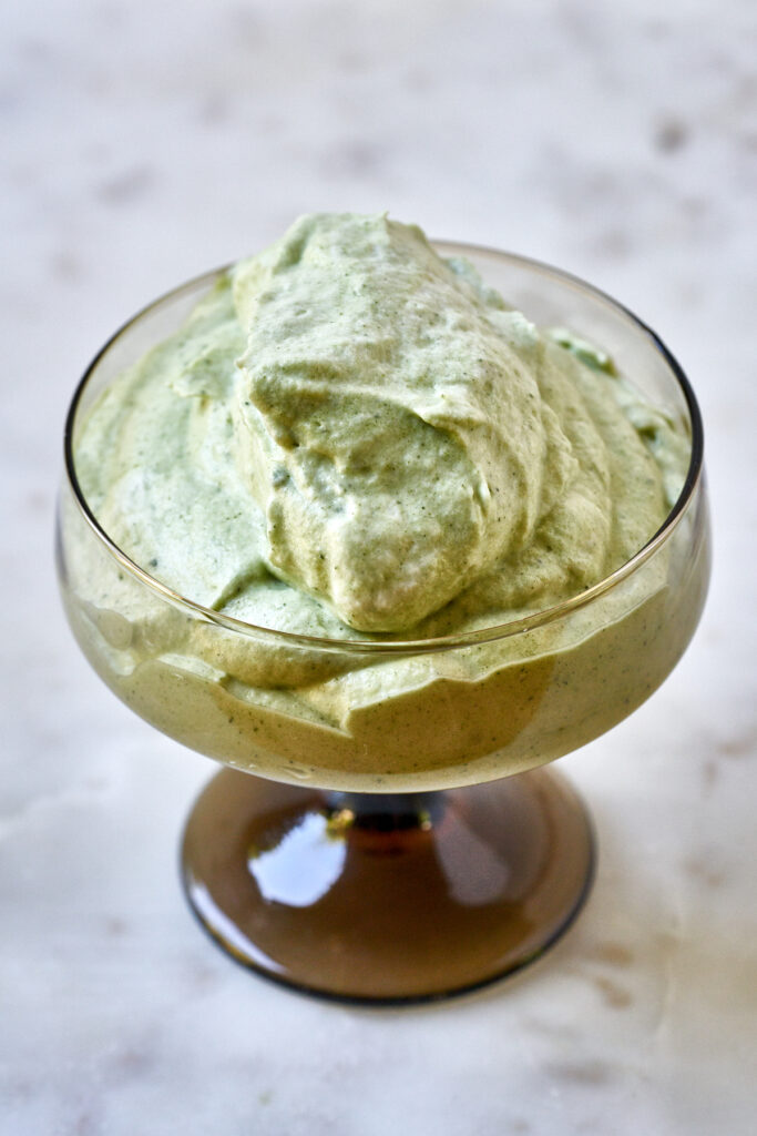 Green tea mousse in a pedestal glass.