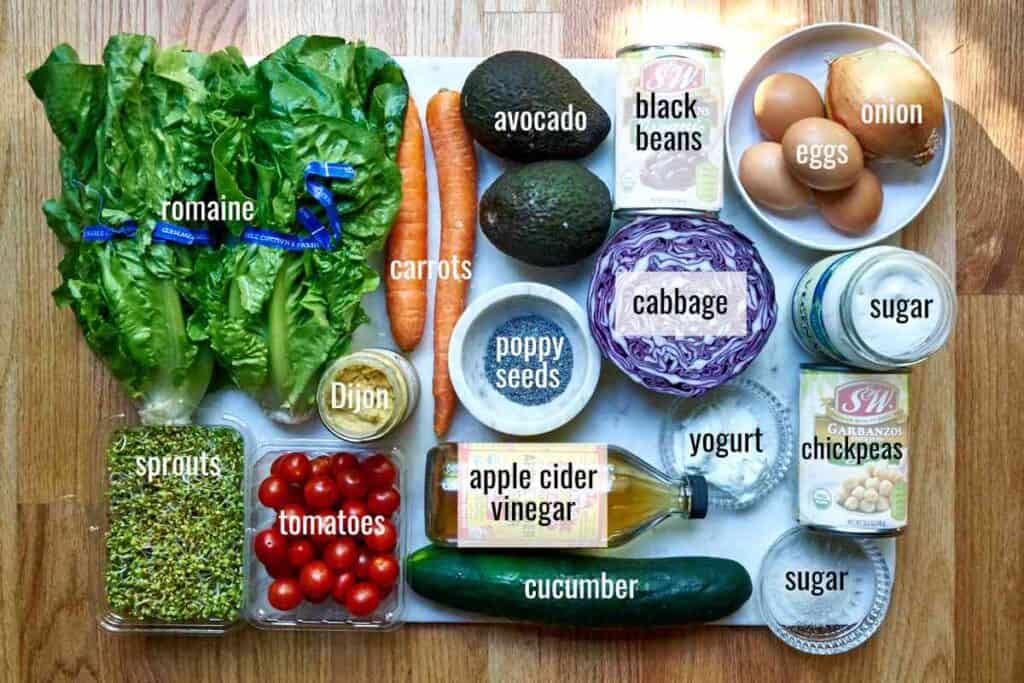 Flatlay of ingredients for meal salad with poppyseed dressing.