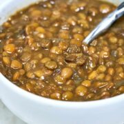 Bowl of lentils with a spoon.