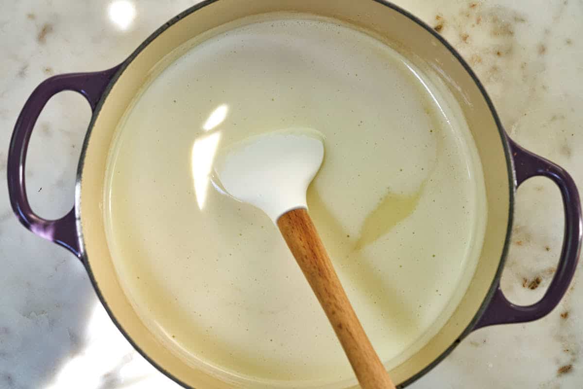 Ice cream base in a pot with a rubber spatula.