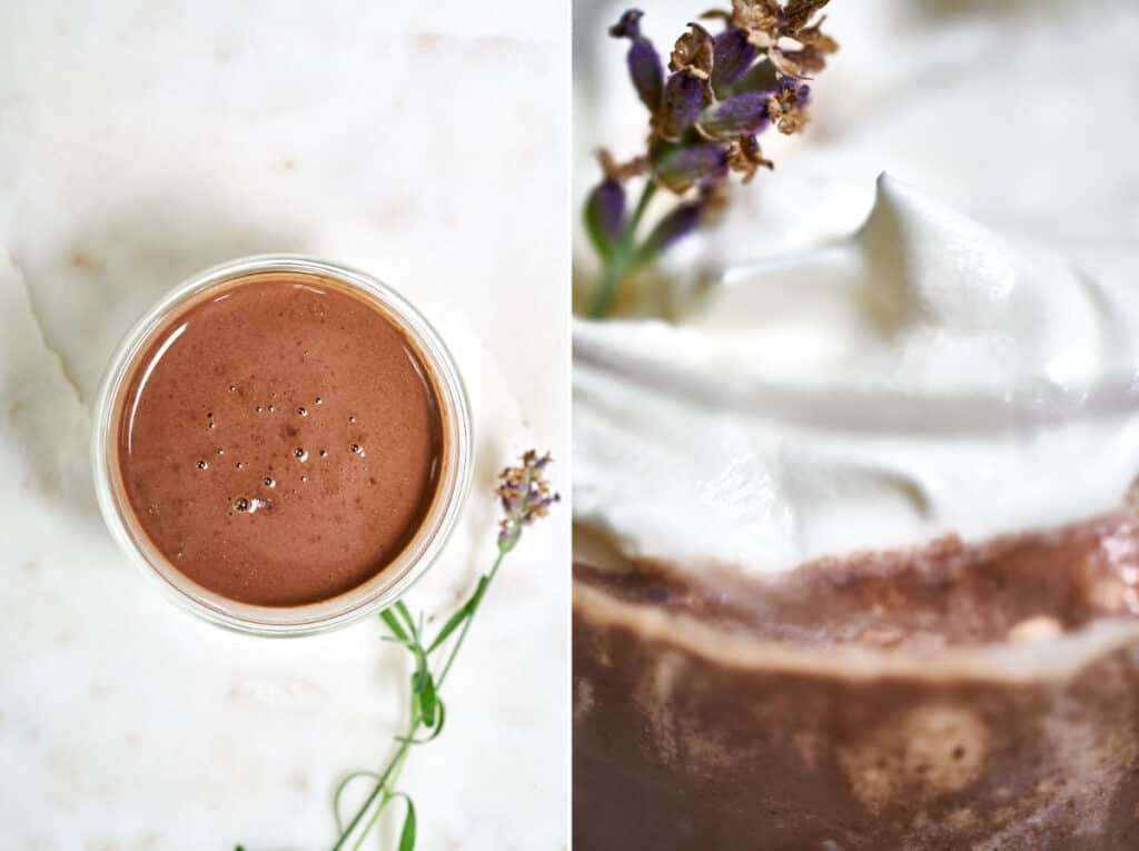Top view of hot chocolate next to a lavender garnish in whipped cream.