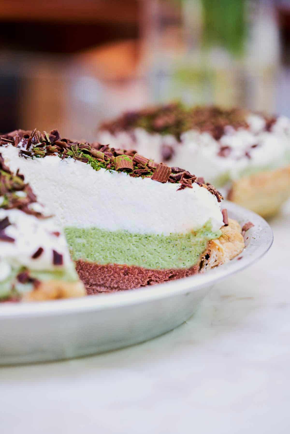 Layered french silk pie with a slice cut out.