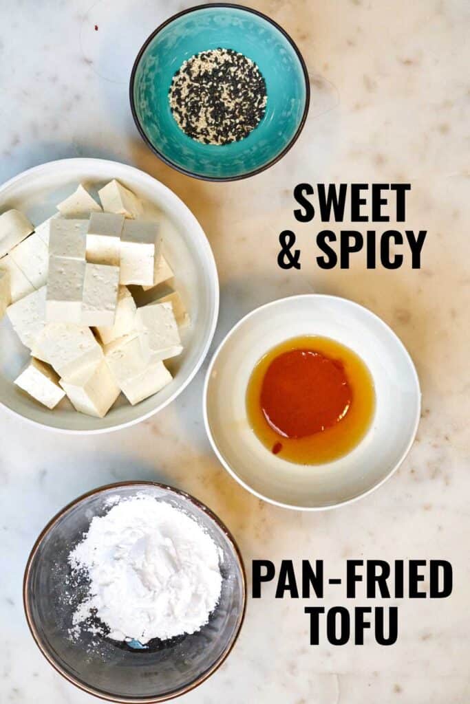 Ingredients for tofu in bowls on a countertop.