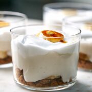 Close up of banana cream pie cup topped with a bruleed banana slice.