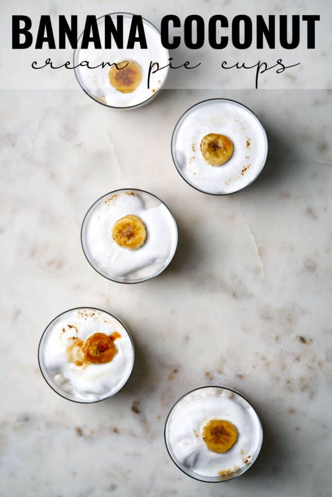 Top view of five banana cream pie cups filled with whipped cream and topped with a bruleed banana slice with title text.