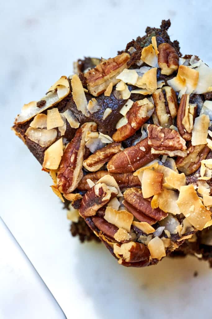 Top view of two slices of cake covered in coconut and pecans.