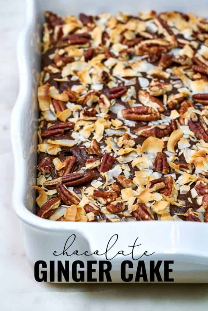 Cake in a white baking dish covered in pecans and coconut after baking with title text.