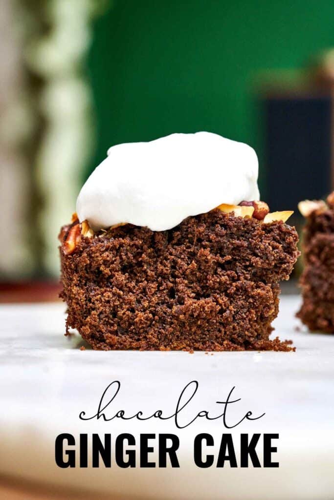 Front view of one piece of cake topped with whipped cream on a white table with green background with title text.