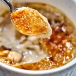 Close up of a bite of creme brulee on a spoon.