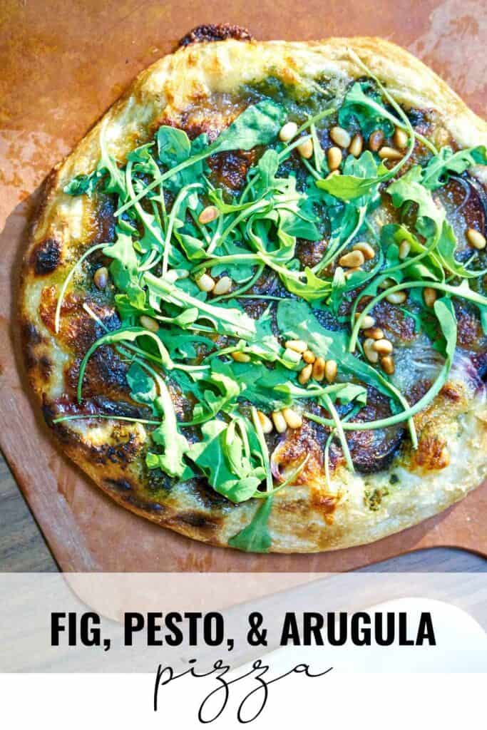 Pizza on a pizza peel with fresh arugula with title text.