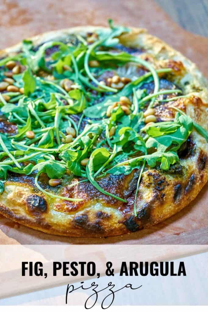 Pizza on a pizza peel with fresh arugula with title text.