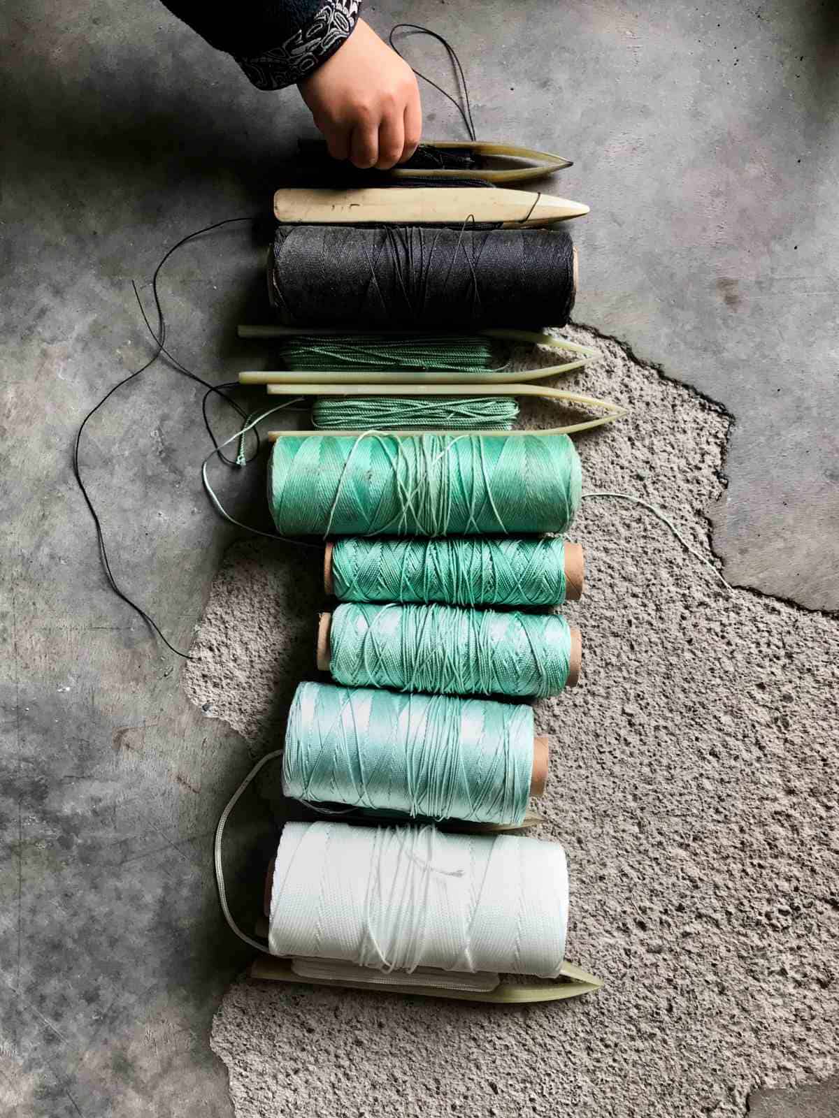 Spools of fishing net thread.