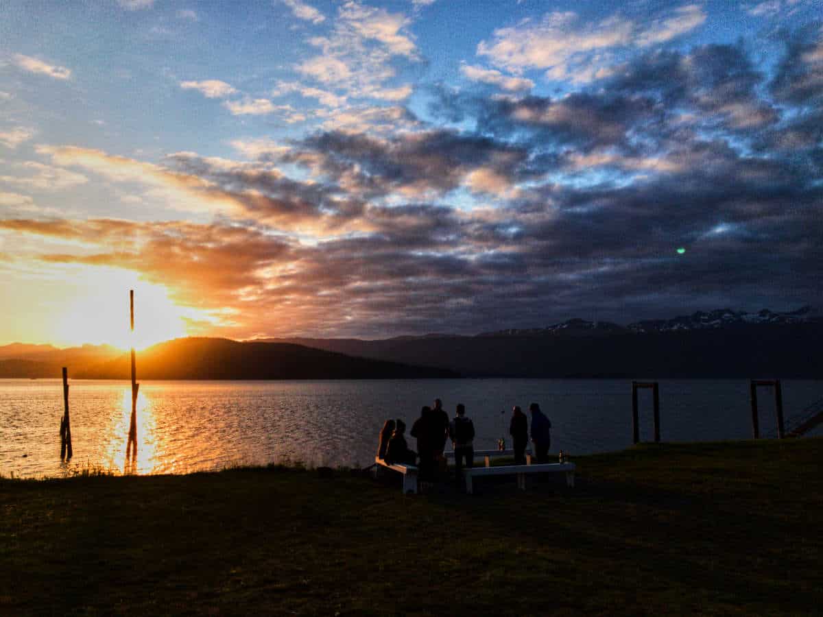 Sunset over water with mountains.