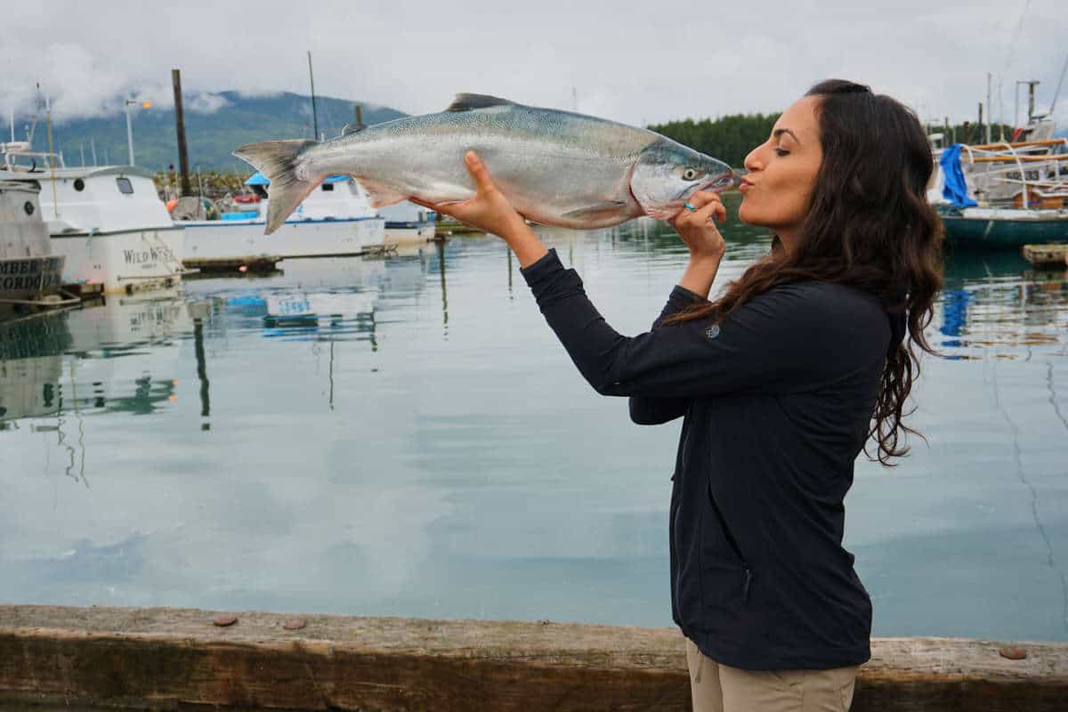 Woman kissing a fish.