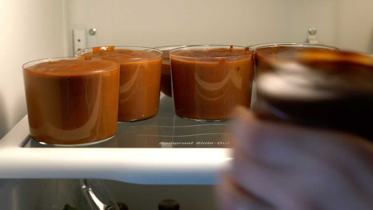 Glasses of pudding in the refrigerator.