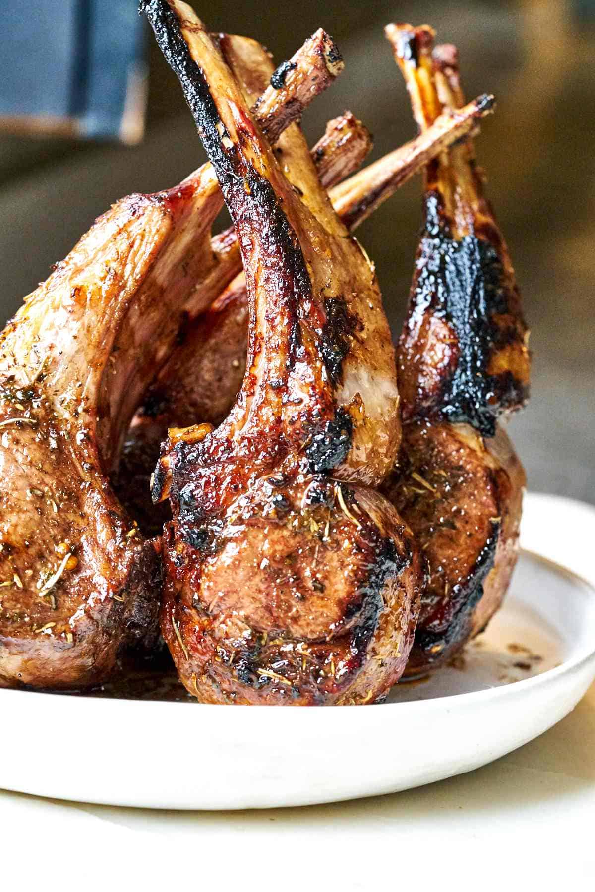 Rack of lamb standing upright on a plate.