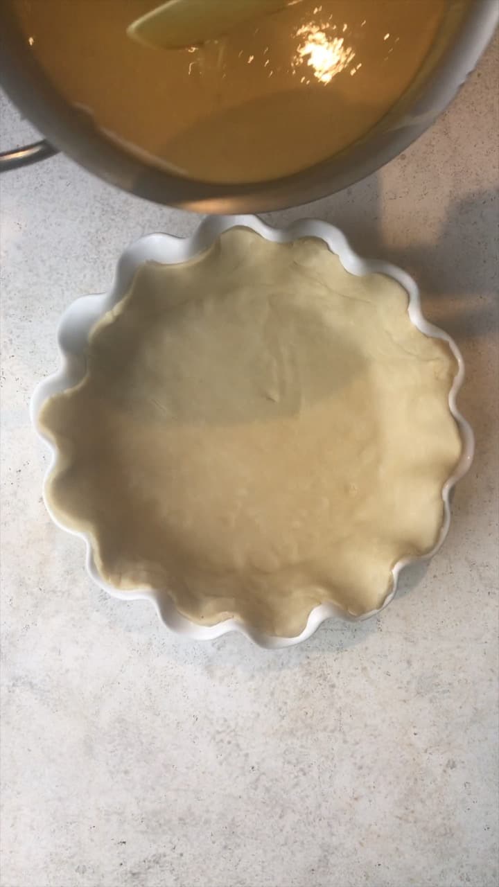 Pie crust in a fluted pie pan.