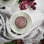 Chia pudding in a cup with flowers.