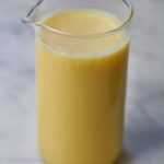 Ghee in a glass with a spout.