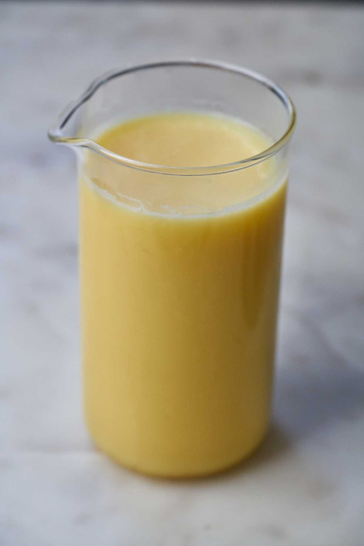 Ghee in a glass with a spout.