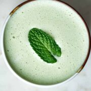 Green latte with a mint leaf on top.