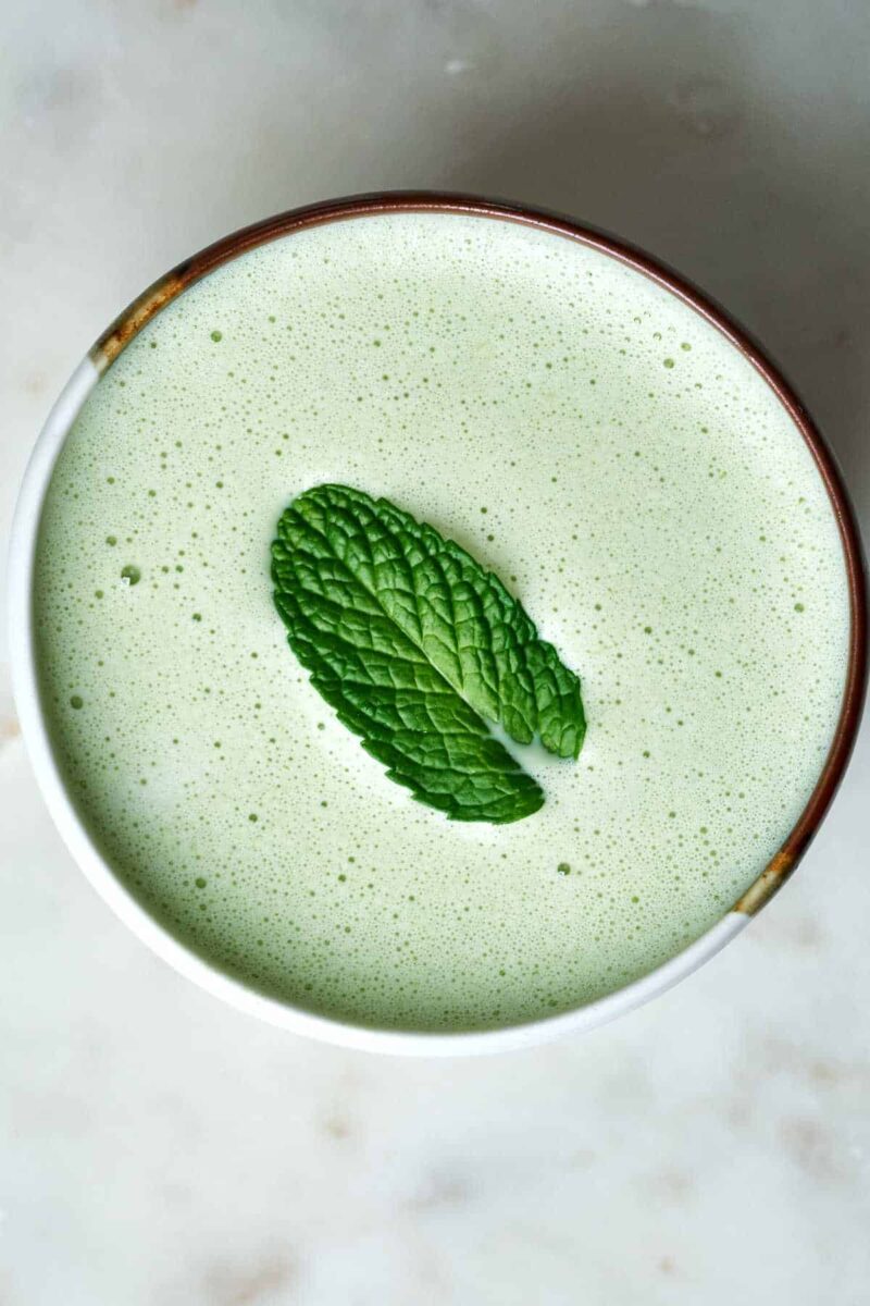 Green latte with a mint leaf on top.
