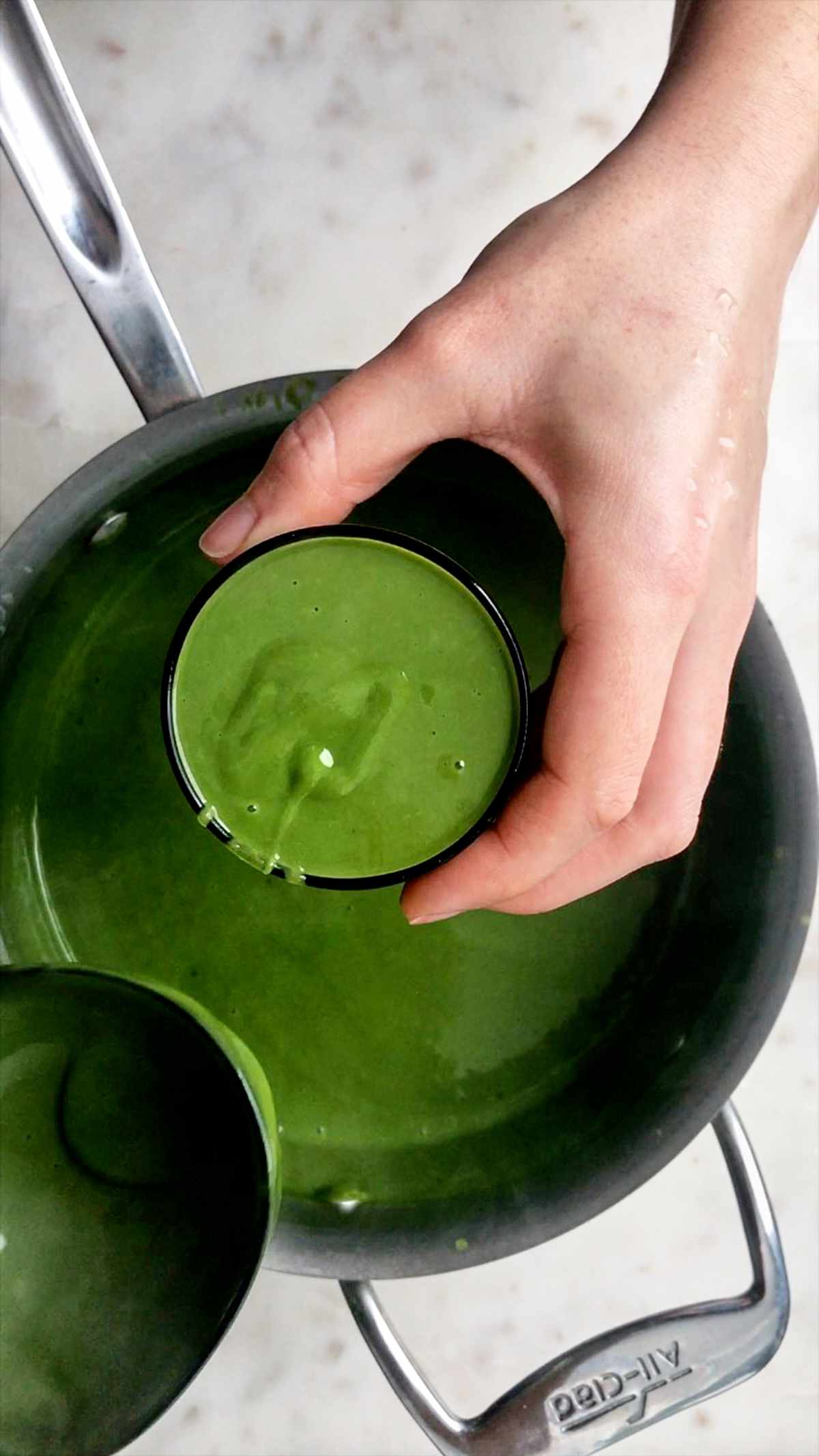 Cup full of warm green pudding.