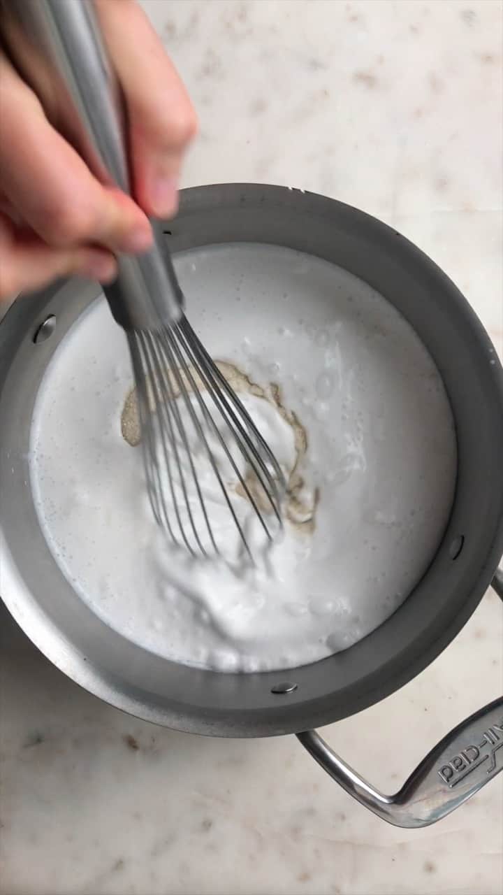Whisking milk in a pot.