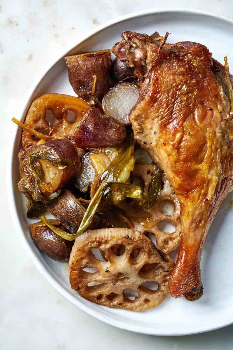 Crispy duck leg with vegetables.