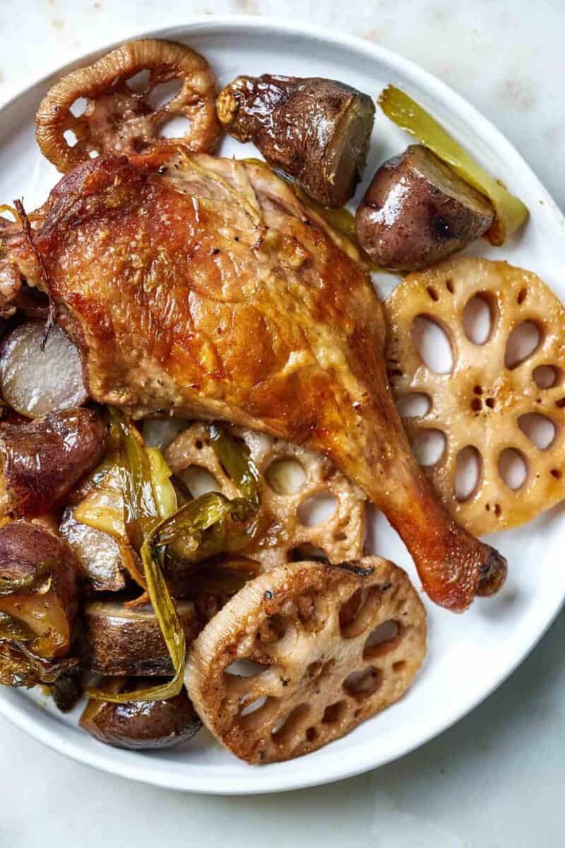 Crispy duck leg with vegetables.