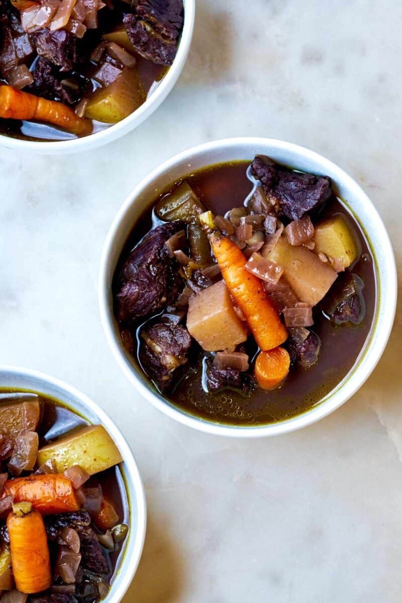 Three bowls of beef stew.