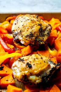 Sheet pan with chicken and vegetables.