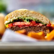 Burger on a tray with fries.