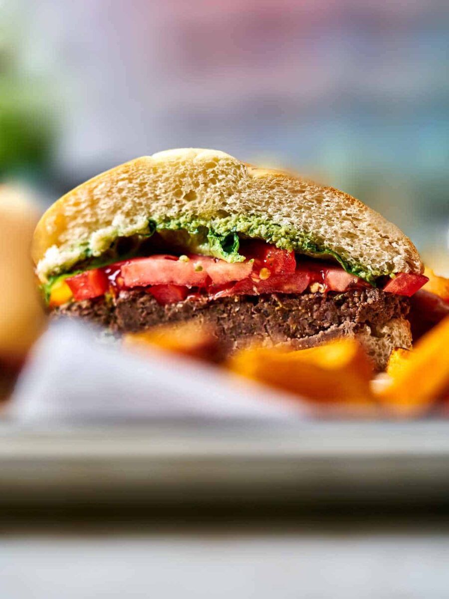 Burger on a tray with fries.