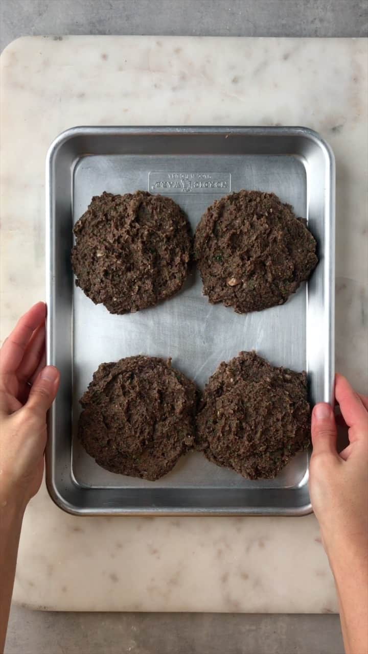 Black bean patties on a baking sheet.