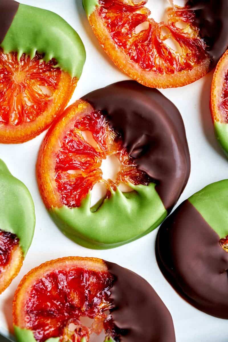 Oranges dipped in chocolate and green chocolate.