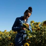 Woman in sunflower field.