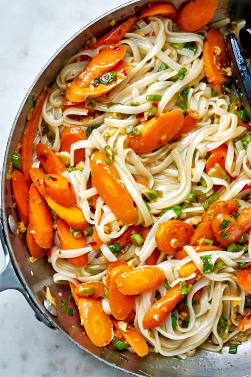 Noodles with carrots in a pan.