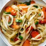 Noodles with carrots in a bowl.