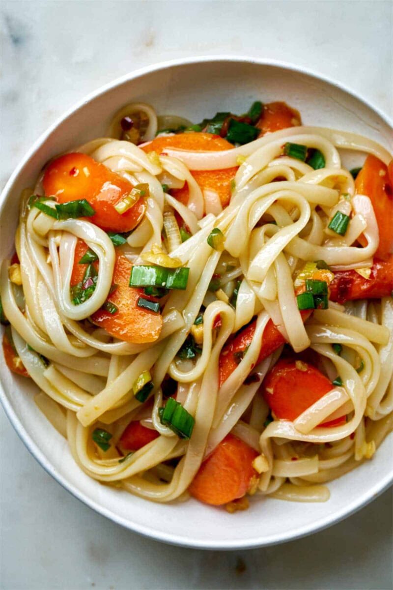 Noodles with carrots in a bowl.