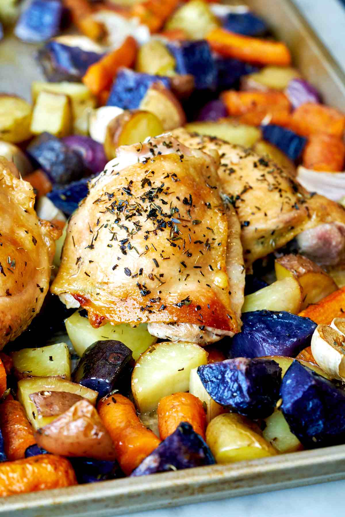 Roasted chicken thighs on sheet pan.