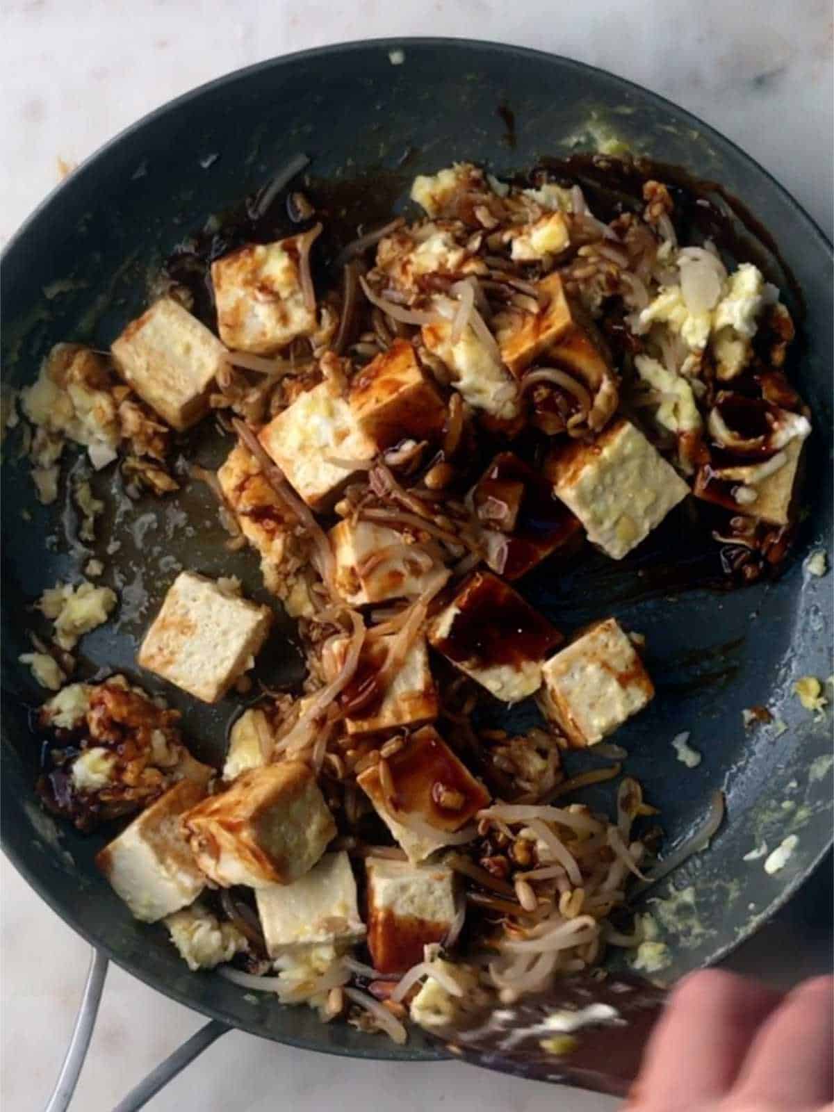 Saucy tofu in a pan.