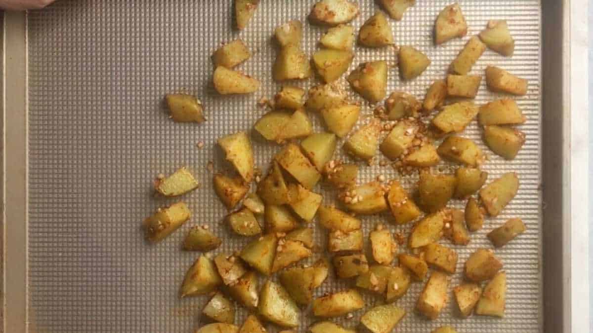 Baking sheet with diced potatoes.